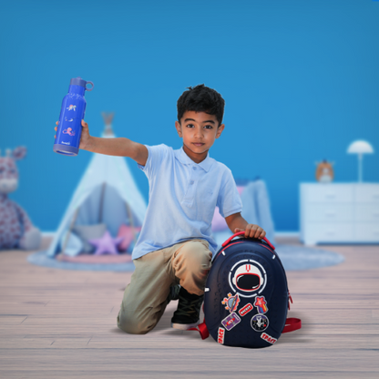 Boy holding the Bentotss Ocean Splash Blue Sipper bottle and sitting next to a matching Bento Bag