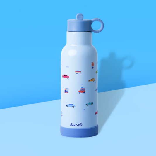 Bentotss Travel Trot Light Blue Stainless Steel Bento Sipper bottle with a small vehicle pattern, displayed against a bright blue and light blue background
