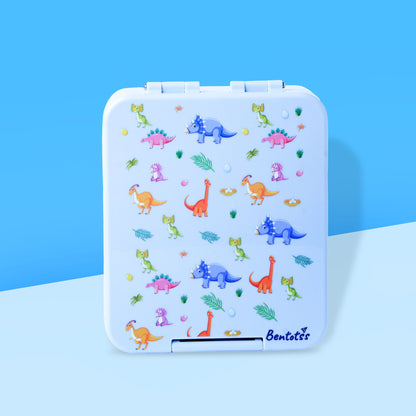 Bento kids lunchbox with dinosaur prints in light blue by Bentotss, placed on a blue background