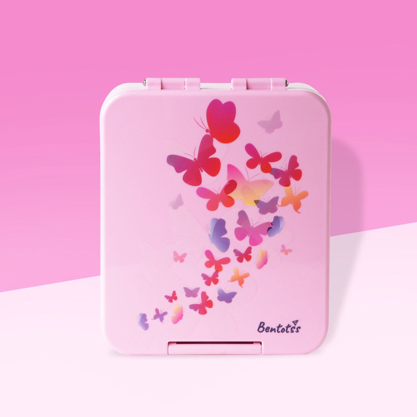 Bentotss Butterfly Magic Pink Bento Box with a vibrant scattered butterfly design, displayed on a pink surface