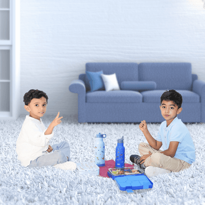 Two boys playing indoors with their Bento stainless steel sipper bottles by Bentotss on a soft play mat