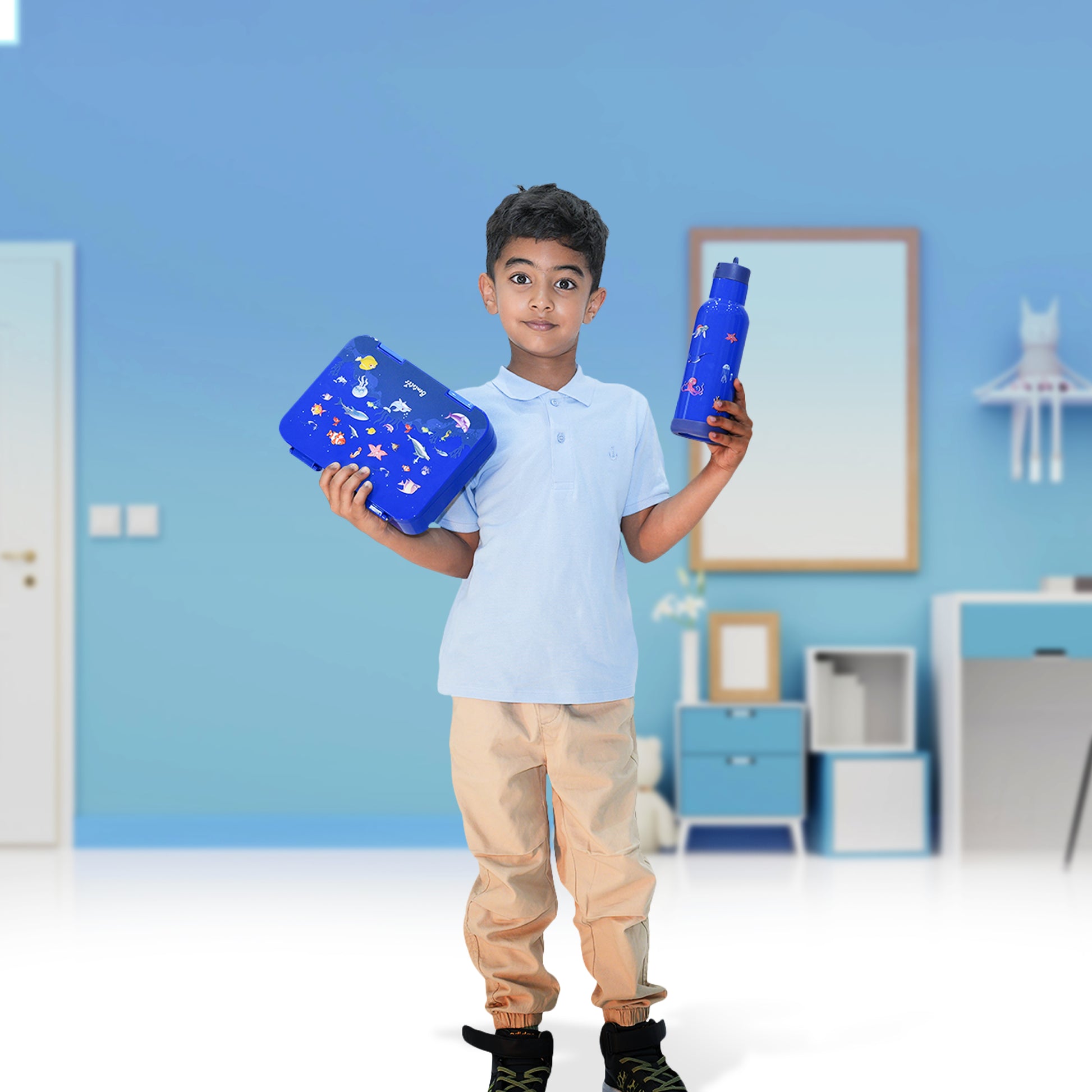 Boy holding Colorful Bento lunch box and matching sipper bottle