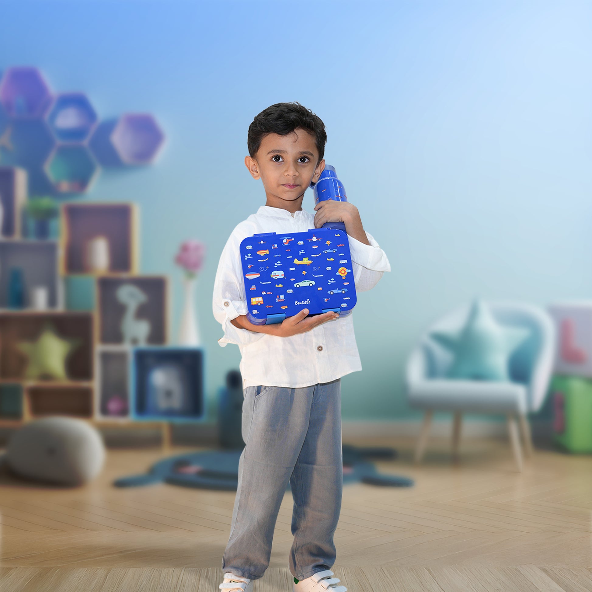 Boy holding Speedy Ride Blue Bento Box – fun travel-themed lunchbox for school